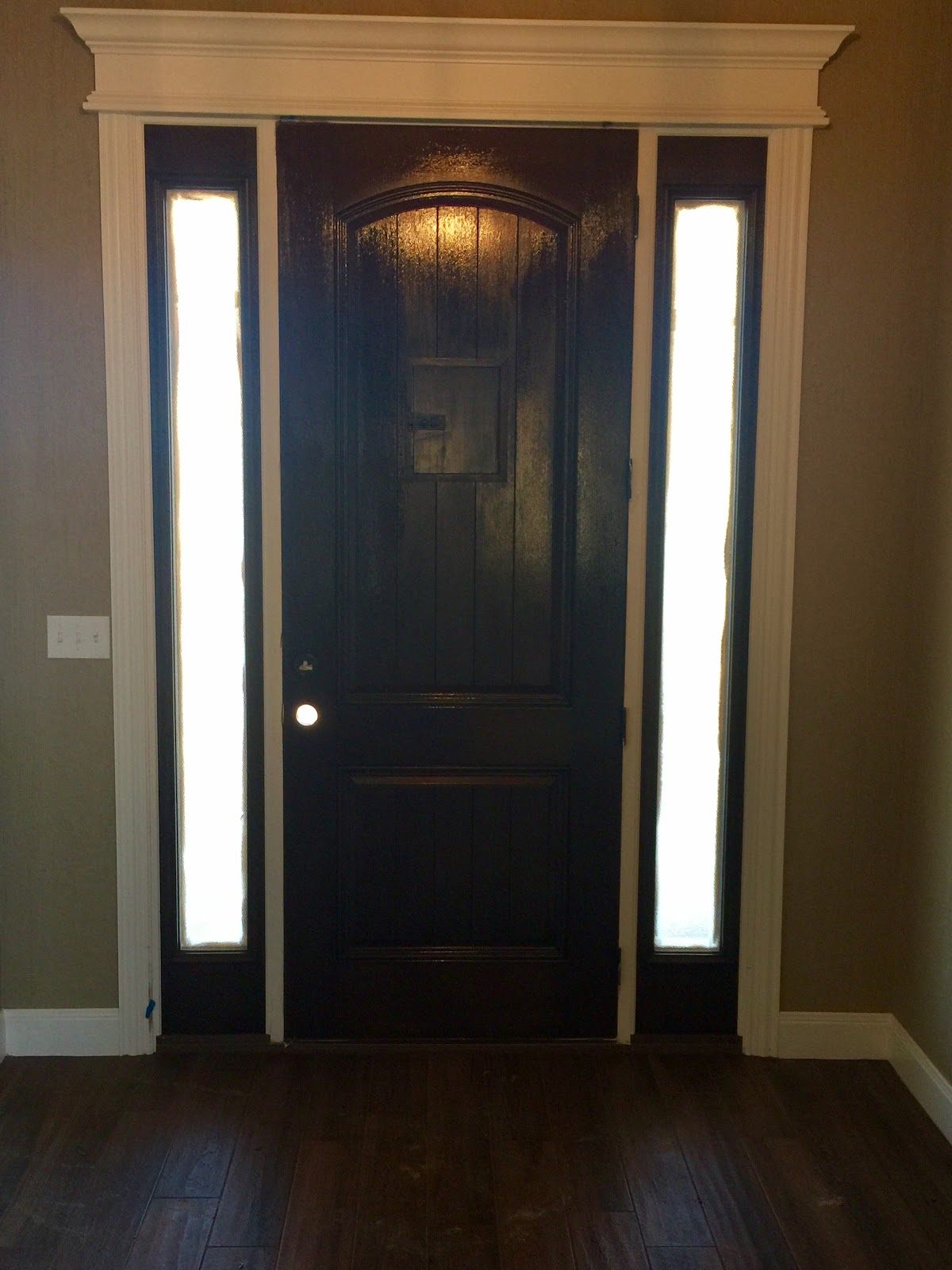 Interior door painted dark with crisp white trim moulding